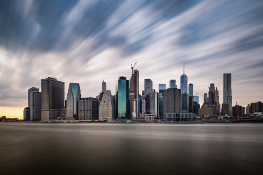 Dark clouds comming quickly over the New York Lower Manhattan during cloudy day in a long exposure panorama photograph
