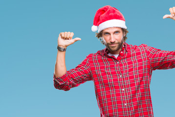 Handsome hispanic man model wearing santa claus christmas over isolated background looking...
