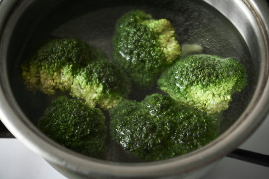 Broccoli is cooked in metal pan. Close-up.