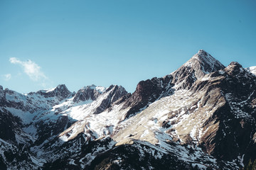 Fototapeta na wymiar Snow covered mountain with a clear blue sky