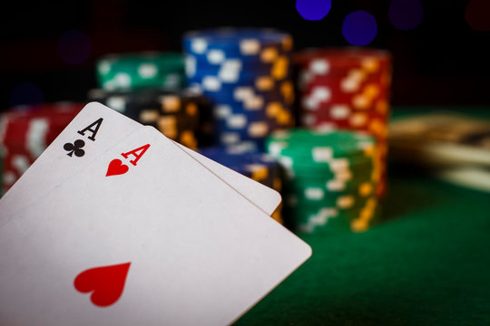 Two aces on the poker table with chips