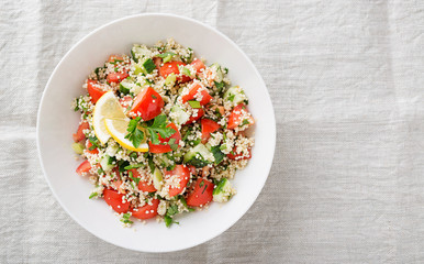Couscous with parsley, tomato, lemon and olive oil. Traditional Arabic Salad Tabbouleh. top view