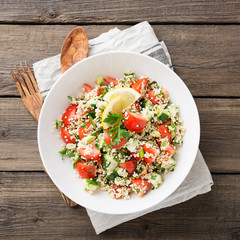 Couscous with parsley, tomato, lemon and olive oil. Traditional Arabic Salad Tabbouleh. top view