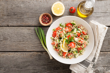 Couscous with parsley, tomato, lemon and olive oil. Traditional Arabic Salad Tabbouleh. top view