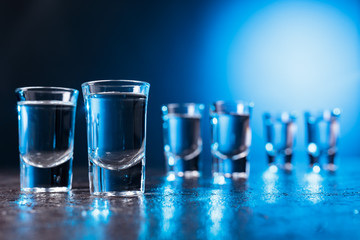 Glasses of Vodka lit with blue backlight.
