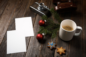 Photos, camera, pine tree branch and cup of coffee.