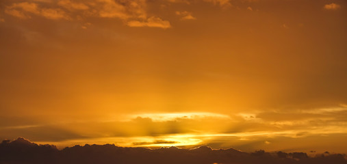 Beautiful orange clouds and sky at sunset. Colorful sunbeam background.