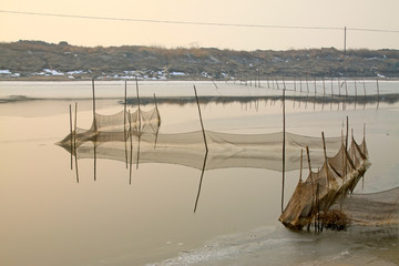 nets in shores of an icy river