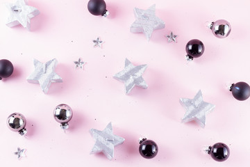 Gray Christmas decorations on plain pink background, top view