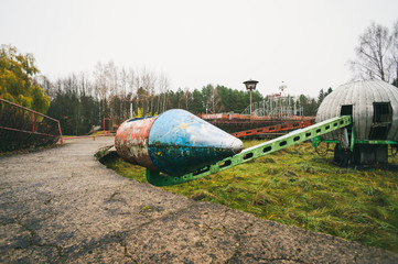 Old rocket ride carousel in abandoned amusement park