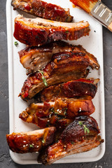 Delicious barbecued ribs seasoned with a spicy basting sauce. lose-up, copy space.
