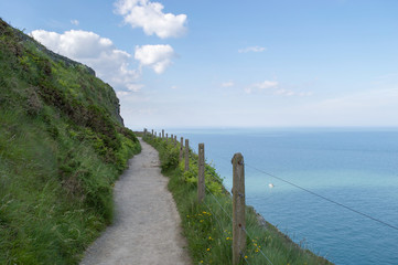 Cliff top path landscape over Irish sea between Bray and Greystones in Co. Wicklow, Ireland on a sunny summer day