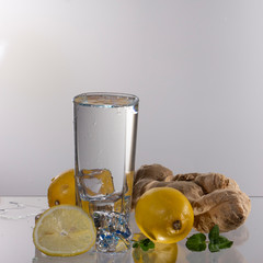 A glass of lemonade on a light background with splashing water