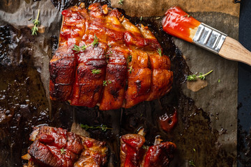 Grilled pork ribs on baking paper, top view. Copy space.