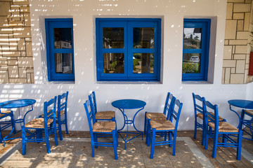 Blue chairs and tables in the restaurant. A place to eat on the seashore.