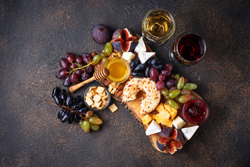 Cheese plate with grapes and wine