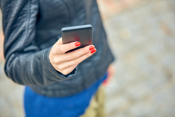 Woman using modern smartphone on the street.