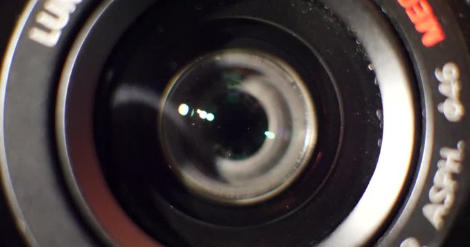 Close up macro shot of a modern photography camera zoom lens using the autofocus feature as it tries to lock focus during a video.