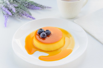 Cream caramel with blueberries on white background. Caramel pudding. Cream pudding.
