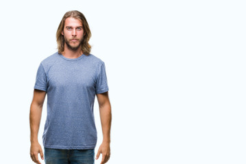 Fototapeta premium Young handsome man with long hair over isolated background with serious expression on face. Simple and natural looking at the camera.