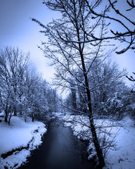 A cold river during a snow storm 