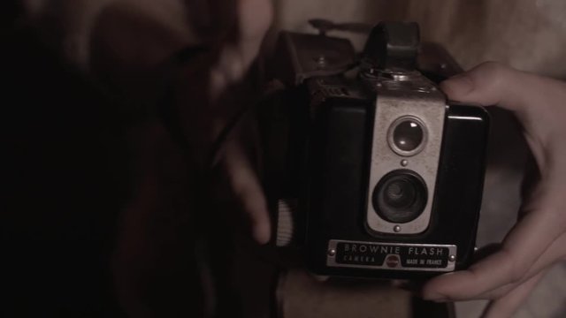 Opening old retro brownie camera from case