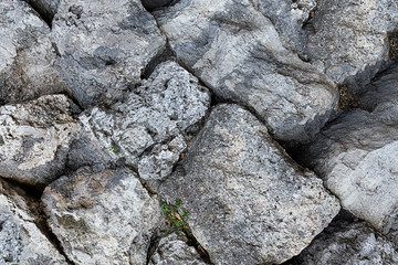 oblique series of large gray stones uneven background weathered rectangle cobblestone powerful base