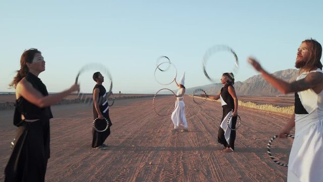 People make ring juggling show at sundown shaky footage