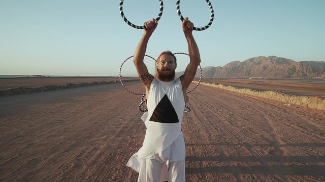 Man in foreground with group shows rings performance shaky footage slow motion