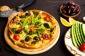 Pizza with marijuana leaves and organic ingredients