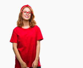 Young beautiful woman over isolated background looking away to side with smile on face, natural expression. Laughing confident.