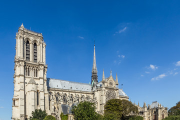 Obraz premium Notre Dame Cathedral, Paris, France, against a blue sky.