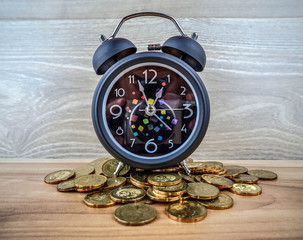 Time is money. Watch and coins. Alarm clock on metal malaysia cents