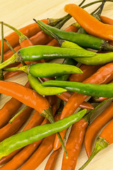 chili background pods of hot peppers bright base of salsa hot sauce shirachi traditions of Asia