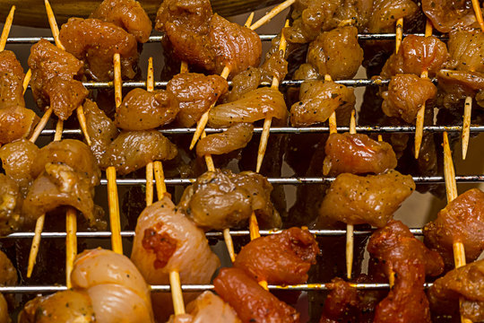 set billet drying meat pieces of flavored pork chicken mix on wooden skewers on a background of iron strip