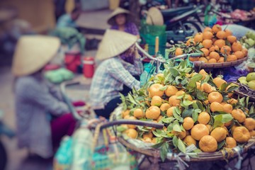 Fresh vegetables and fruits in traditional street market in Hanoi, Vietnam.