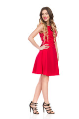 Smiling Woman In Red Dress Is Looking Down Over Shoulder