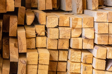 warehouse stack of lumber dried light beige pine boards floor bars square end pattern building materials eco traditional europe