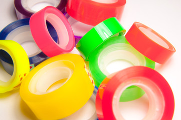 Group of colorful scotch tape adhesive. Many rolling tapes.