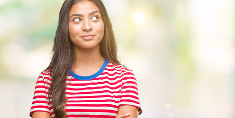 Young beautiful arab woman over isolated background smiling looking side and staring away thinking.