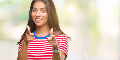 Young beautiful arab woman over isolated background pointing fingers to camera with happy and funny face. Good energy and vibes.