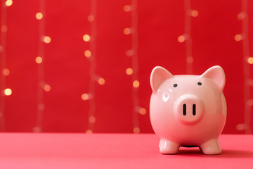 A piggy bank saving and investment theme on a shiny light red background