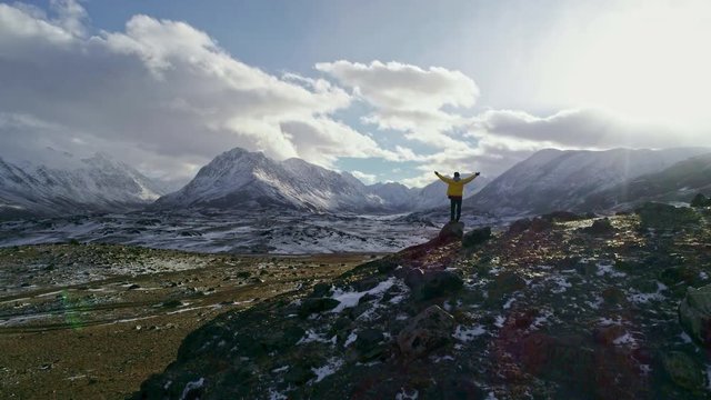 Young Hiker Reaching The Top Outstretched Arms Success Pose At Sunset In Snowy Mountain Range Aerial Flight Epic Victory Life Gratefulness Religion Concept