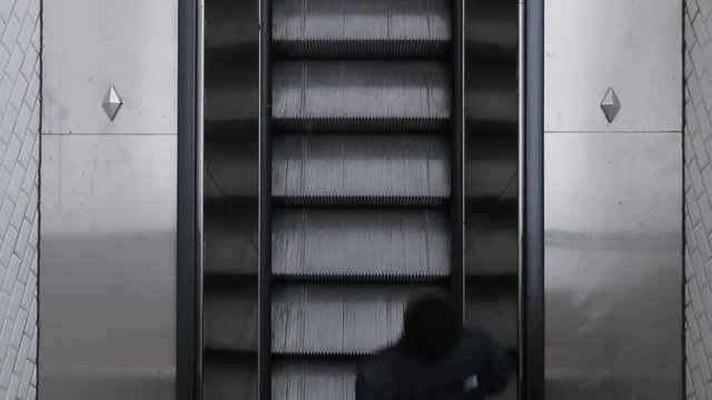 Top Down View Of Moving Up Escalator In Metro. Man Going Up To Escalator