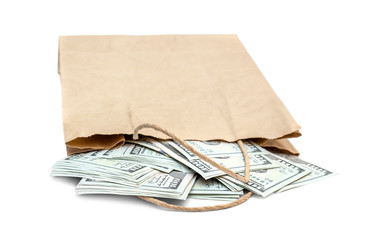 Money scattered from paper bag on white background.