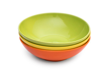 Stack of colorful bowls on white.