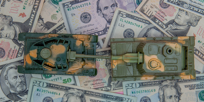 tank against the background of dollars. Concept of war