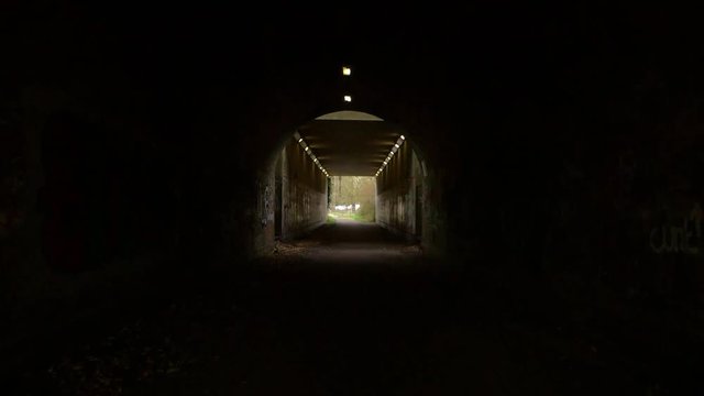 A fantastic tunnel with graffiti along the sides