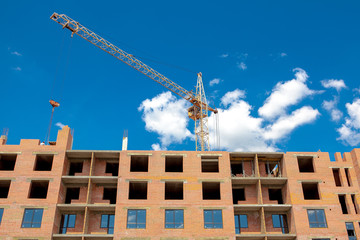 Construction crane over a building under construction. Construction site background