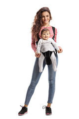 Fit young mother with a baby in a carrier